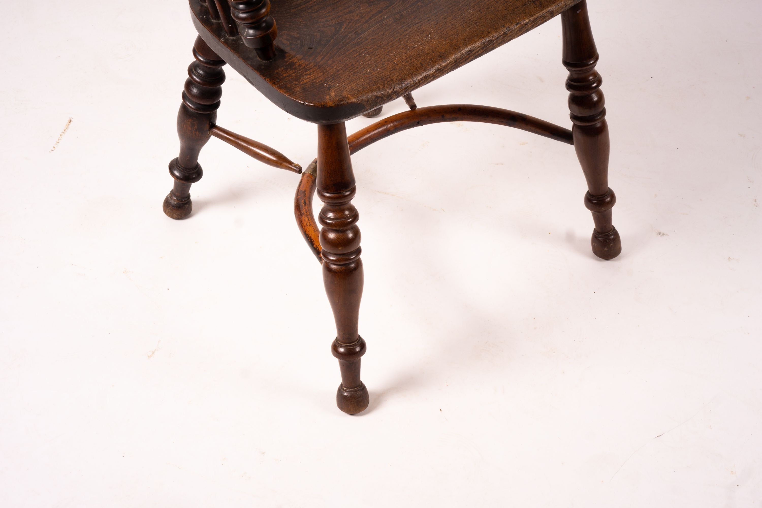 A 19th century yew and elm Yorkshire area Windsor elbow chair with crinoline stretcher, width 60cm, depth 45cm, height 93cm